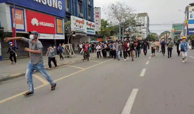 People evacuate an injured demonstrator during a protest in Myitkyina 