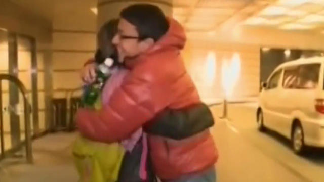 CBS News' Lucy Craft embraces her son Kohei as they're reunited four days after the March 11, 2011, earthquake and tsunami that devastated the northeast Japan region where Kohei was in high school. 