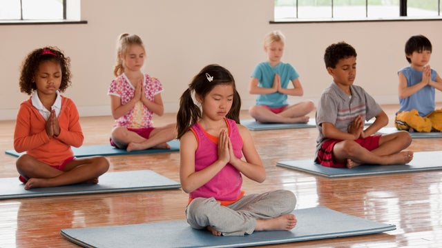 Children exercising in yoga class 