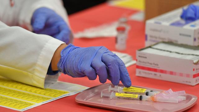 Female doctor giving covid-19 vaccine to a toddler 