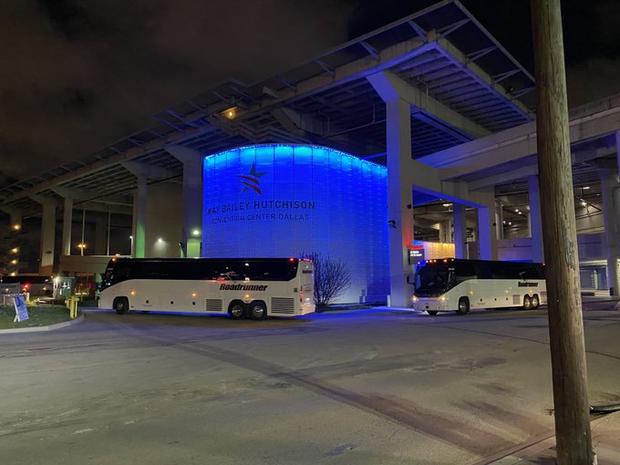 Buses arrive outside KBH Convention Center in Dallas 