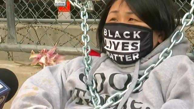 cbsn-fusion-protester-chains-herself-to-fence-outside-derek-chauvin-courthouse-thumbnail-681145-640x360.jpg 