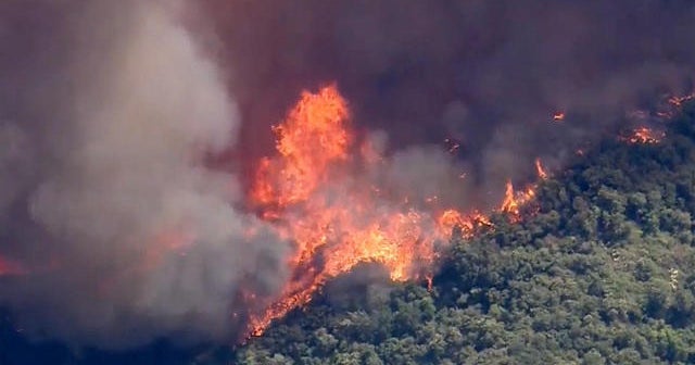 Giant wildfires grow in California during heat wave - CBS News
