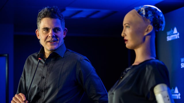 David Hanson, SingularityNET Founder (L), gives a press 