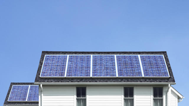 Solar panels on roof of white house 