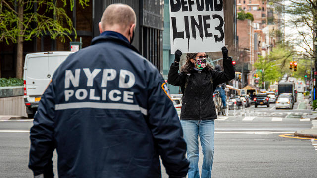 NYPD officer seen approaching a participant blocking a 