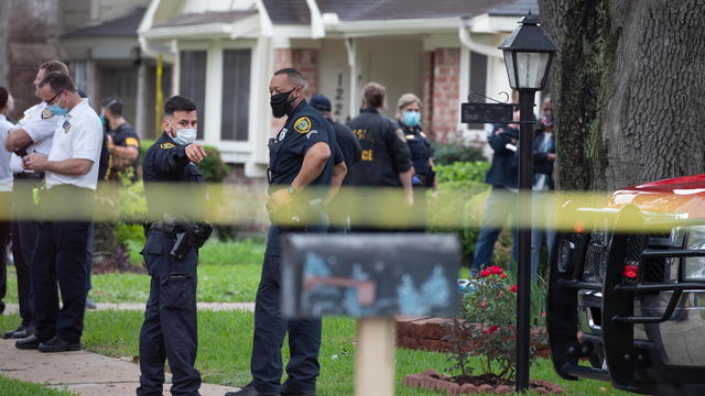 Police officials stand outside Houston residence 