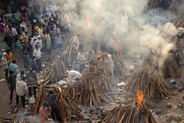 People cremate their relatives, who died due to the coronavirus disease (COVID-19), at a crematorium ground in New Delhi