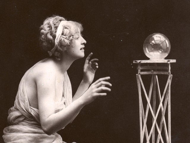 Woman Kneels Before Crystal Ball