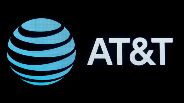 FILE PHOTO: The company logo for AT&T is displayed on a screen on the floor at the NYSE in New York 