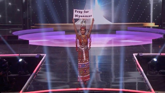 Ma Thuzar Wint Lwin, Miss Universe Myanmar, holds the "Pray for Myanmar" sign during Miss Universe pageant's national costume show, in Hollywood 