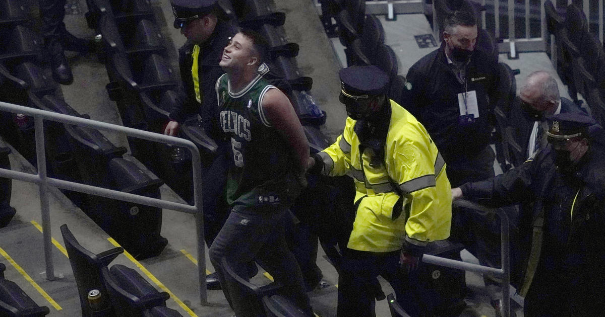 In ugly incident in Boston, fan tosses water bottle at Kyrie Irving, who  blames underlying racism - CBS News