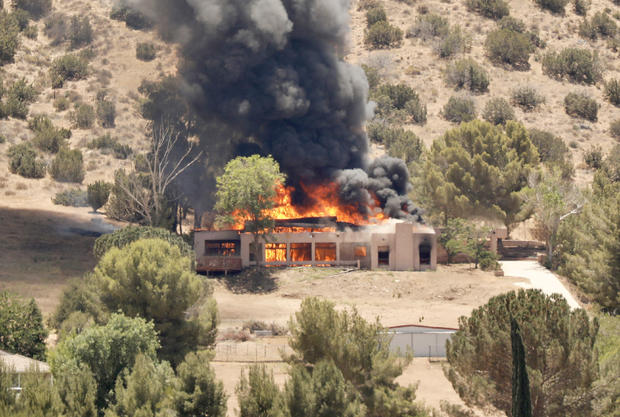 A home burns in the 2600 block of W Bent Spur Drive in Acton on Tuesday, June 1, 2021. It is believed this incident is related to a shooting at nearby L.A. County Fire Station 81 in Augua Dulce, where one firefighter was killed and another wounded. 