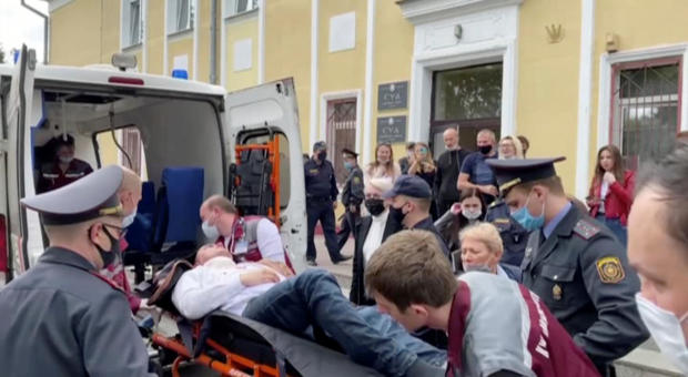 A still image taken from video footage shows Belarusian prisoner Stepan Latypov, who was arrested during a security crackdown on mass protests following a contested presidential election in 2020, being carried out of a court building after he stabbed hims 