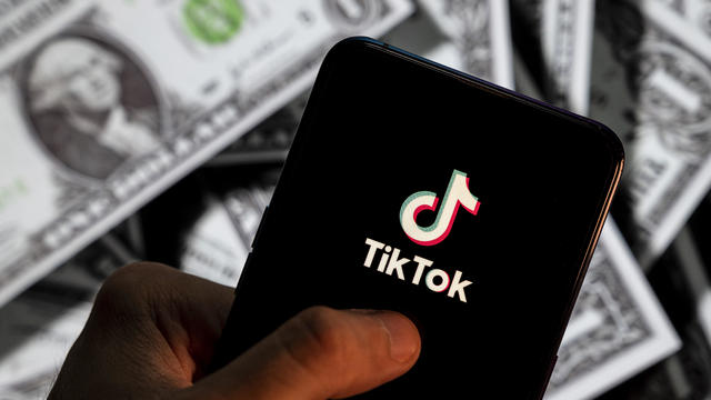 In this photo illustration, a TikTok logo seen displayed on 