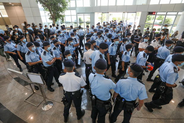 Police officers gather at the headquarters of Apple Daily in Hong Kong 
