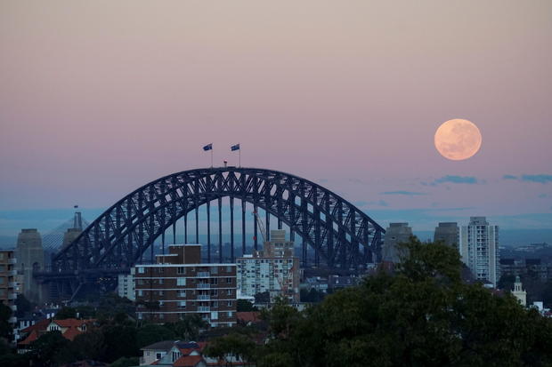 The 'strawberry moon' is seen over Sydney Harbour Bridge in Sydney 
