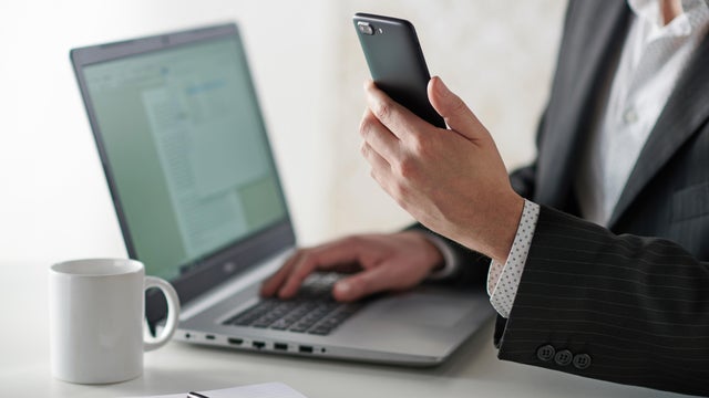 Businessman Using Smartphone And Laptop 