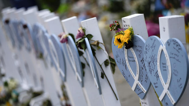 Flowers and messages of love adorn wooden hearts with the names of victims of the Champlain Towers South building collapse, at a makeshift memorial near the site July 12, 2021, in Surfside, Florida. 