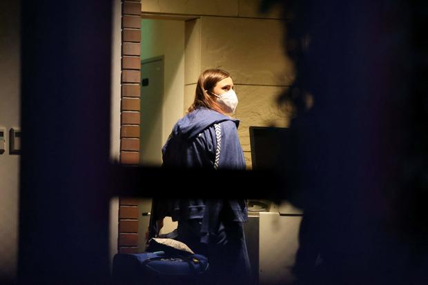 Belarus Olympian Krystsina Tsimanouskaya, who claimed her team tried to force her to leave Japan, walks with her luggage inside the Polish Embassy in Tokyo on August 2, 2021. 