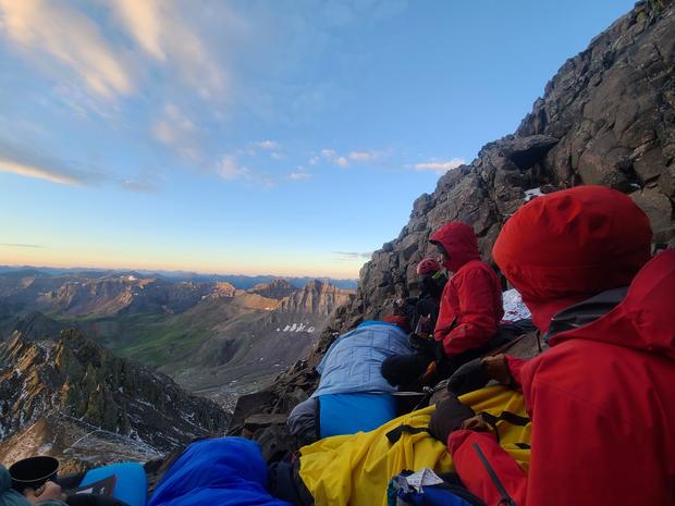 Sneffels Rescue pic4 (rescuers and patient watching sunrise, Ouray Mtn Rescue Team on FB) 