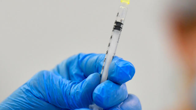 A nurse prepares a COVID-19 vaccine dose at a vaccination center in Dresden, Germany, July 29, 2021. 