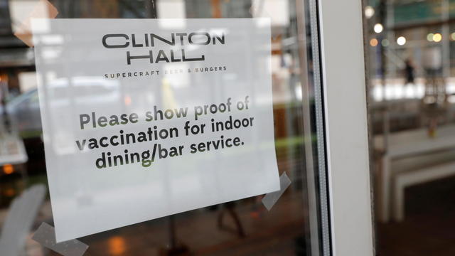 Signage is seen on a window in a restaurant as the vaccine mandate commenced during the outbreak of the coronavirus disease (COVID-19) in Manhattan, New York City 