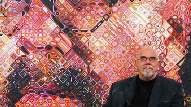 US artist Chuck Close sits in front of o 