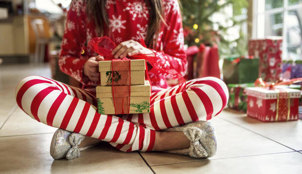 Cute Young Girl Sitting With Christmas Presents 