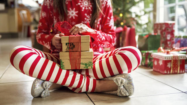 Cute Young Girl Sitting With Christmas Presents 