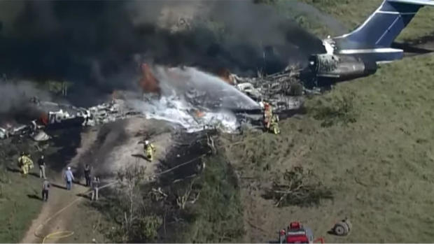 Crews work the scene after a plane attempting to take off near Houston caught fire on October 19, 2021. 