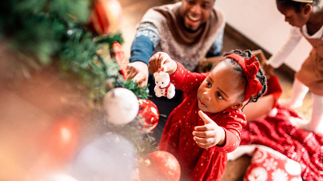 Kids decorating the Christmas tree with their Dad 