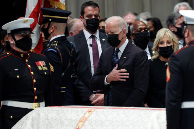 President Biden and first lady Jill Biden look on as the casket of former Secretary of State Colin Powell is carried out after a memorial service at Washington National Cathedral in Washington, D.C., November 5, 2021. 