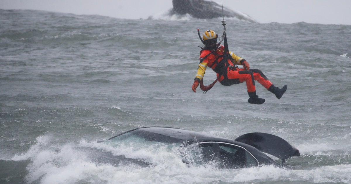 Dramatic video shows Coast Guard pulling woman from submerged car near