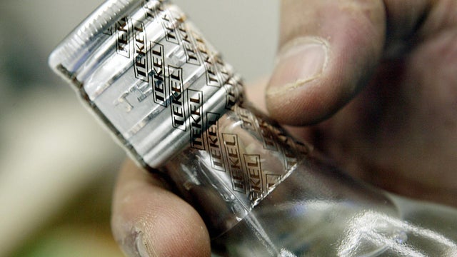 Shop keeper points out the security holo 