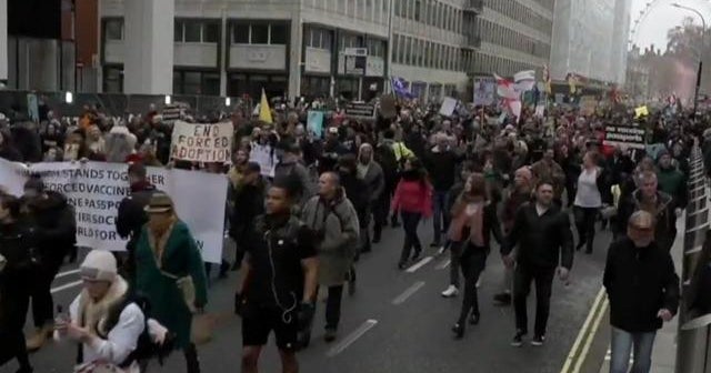 Protests erupt in the U.K. as COVID cases surge - CBS News