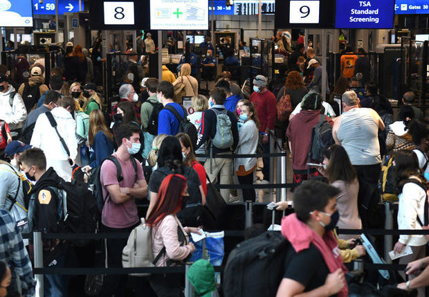 People are seen in a TSA security checkpoint line at Orlando 