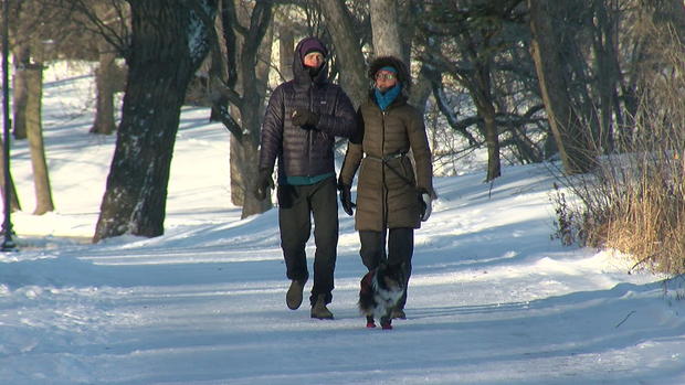 Couple Walks Dog In Subzero Cold 