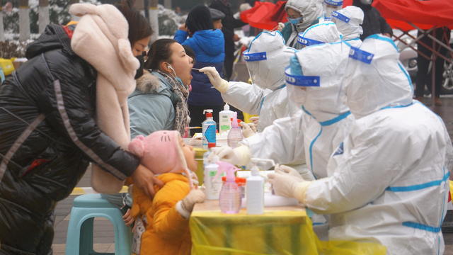 Medical workers collect swabs from residents during a citywide nucleic acid testing in Zhengzhou 