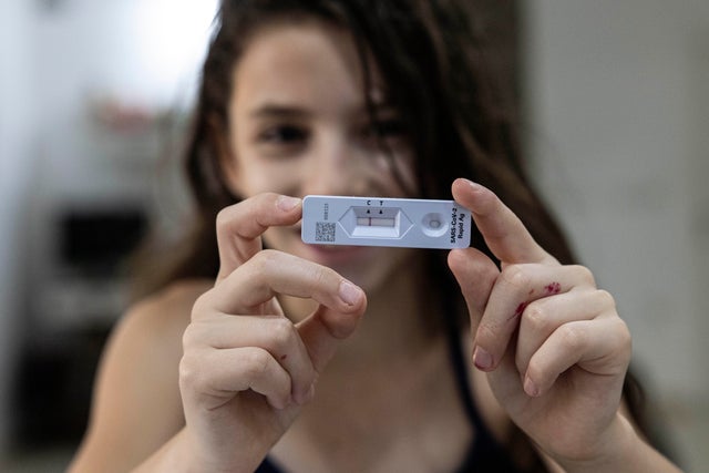 Girl shows COVID test results