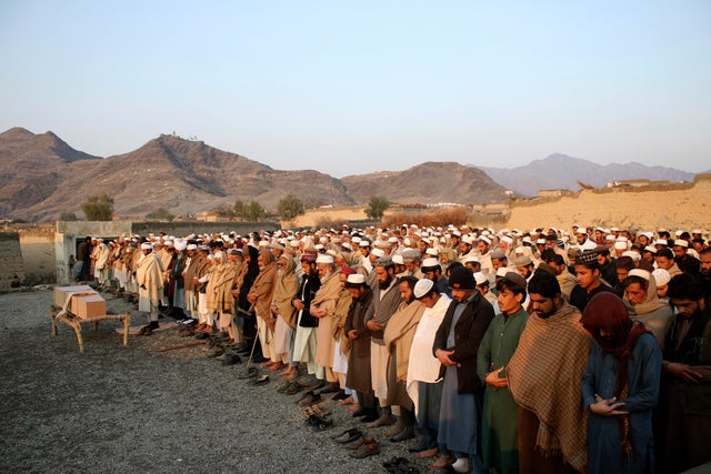 People pray during the funeral for a victim of an explosion in eastern Afghanistan near the border with Pakistan that killed nine children and wounded four, according to the office of a Taliban-appointed governor, in Jalalabad, Afghanistan, January 10, 20 