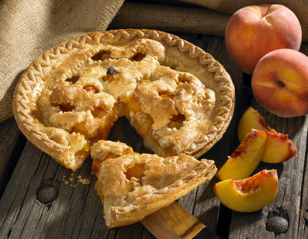 Peach pie on wood rustic background with peaches 