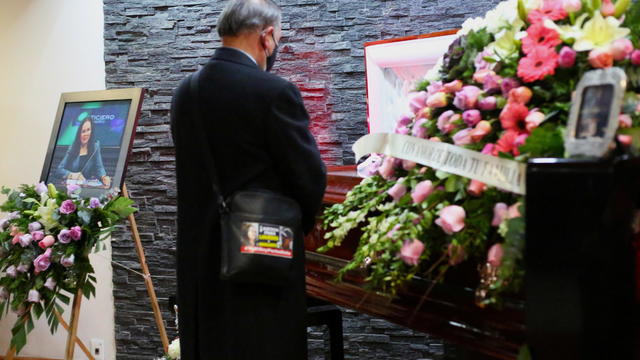 A journalist stands near the coffin of Mexican journalist Lourdes Maldonado during her wake in Tijuana 