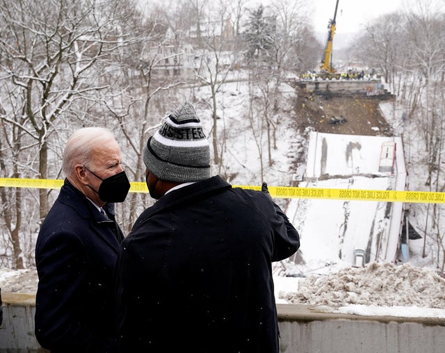 President Biden listens to Pittsburgh Mayor Ed Gainey as they visit the site of a bridge collapse in Pittsburgh, Pennsylvania, January 28, 2022.