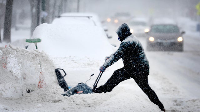 A resident digs out his car on February 2, 2022, in Chicago, Illinois. 