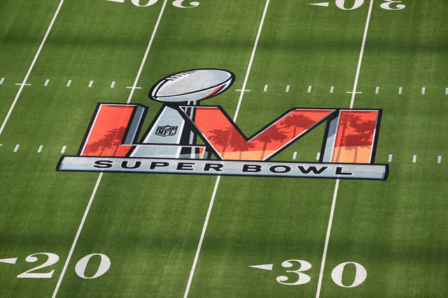 01 February 2022, US, Inglewood: Workers paint the Super Bowl LVI logo on  the field at SoFi Stadium. The Los Angeles Rams and Cincinnati Bengals will  meet here on Feb. 13, 2022 (