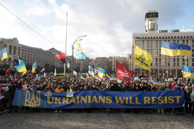 Protesters hold a banner and flags during rally in Kyiv, Ukraine 