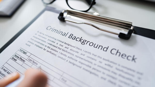 Hand Filling Criminal Background Check Application Form 