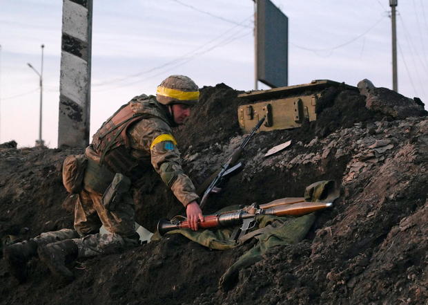 A Ukrainian serviceman holds a rocket-propelled grenade launcher at fighting positions outside Kharkiv 