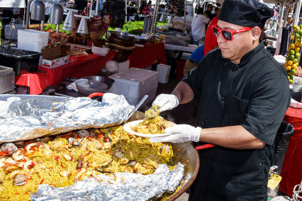A man selling seafood rice paella at the Carnaval Carnival Miracle Mile. 